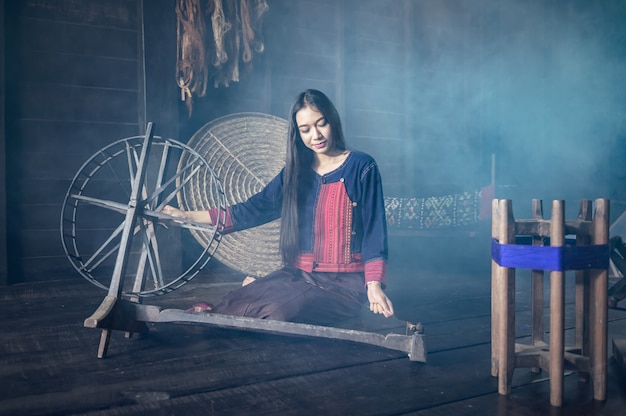 Young women demonstrate to procedure of making Thai Silk weaving in Thailand