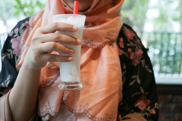 Young women drinking banana milk shake at cafe