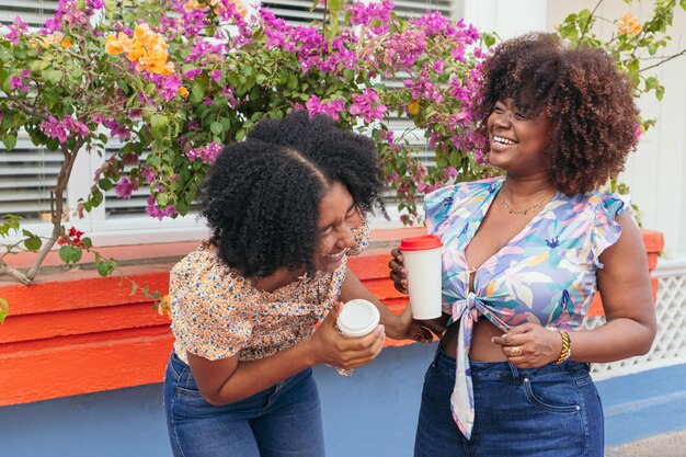 Young women drinking coffee in the street