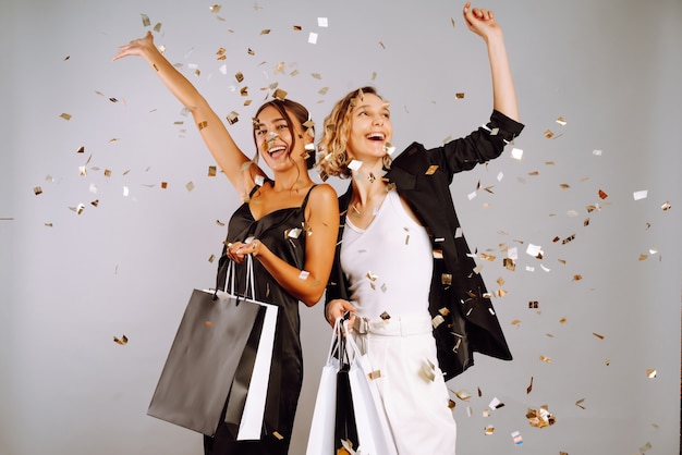 Young women friends with shopping bags