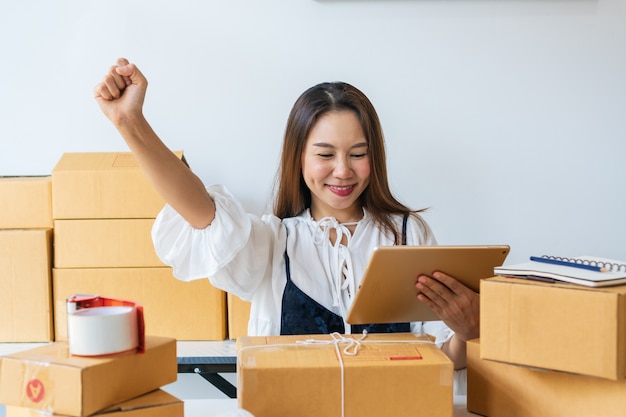 Young Women happy after got big order from customer via e-mail. Online shopping, work at / from home, business and technology, SME entrepreneur concept.