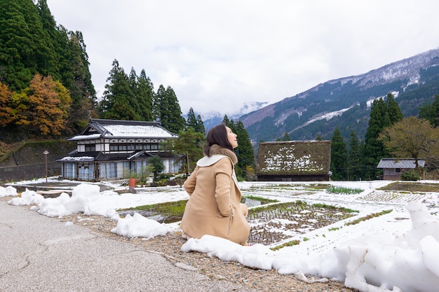 Young Women with Heritage Wooden Farmhouse Village Surrounded in Japan