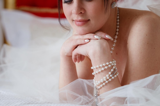 Young women with wedding dress in very bright room Charges the bride at the hotel Wedding photography Portrait of a cute bride