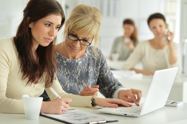 Young women working at office, business concept