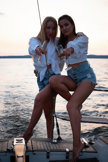 Young women on yacht at sunset