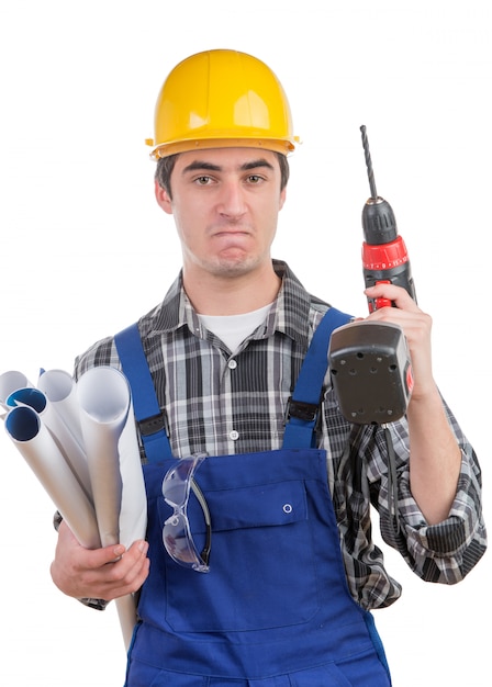 Young worker with a drill is angry