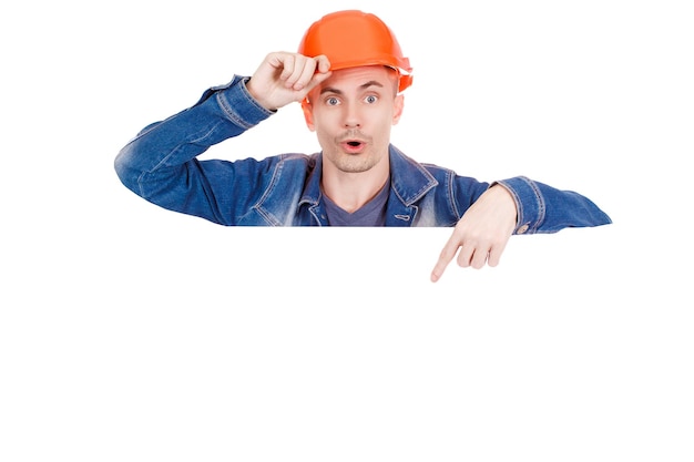 Young working man in orange hard hat with a happy face isolated on white background