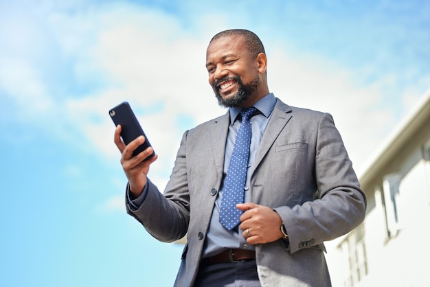 Your dreams will only come true if you work towards it Shot of a businessman using his cellphone while out in the city