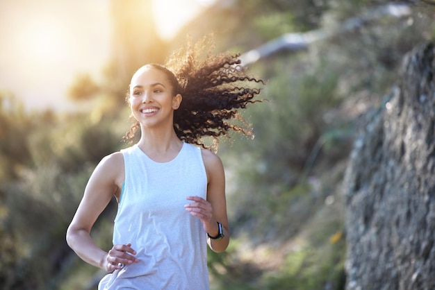 Your giving yourself more than just a workout by going for a run. Shot of a sporty young woman out for a run.