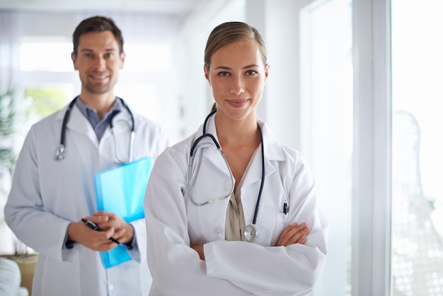 Your medical team Portrait of two smiling doctors standing in a hospital