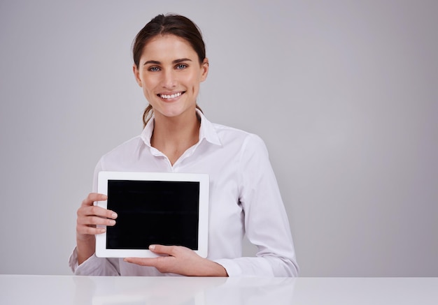 Your online presence is important Studio portrait of an attractive young woman holding a blank digital tablet