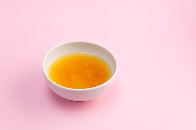 Yuja tea or yuzu tea on pink background Popular Korean tea Honey citron beverage