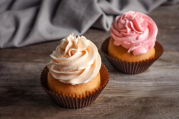 Yummy cupcakes on wooden table