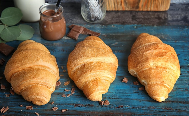 Yummy fresh croissants with chocolate on board