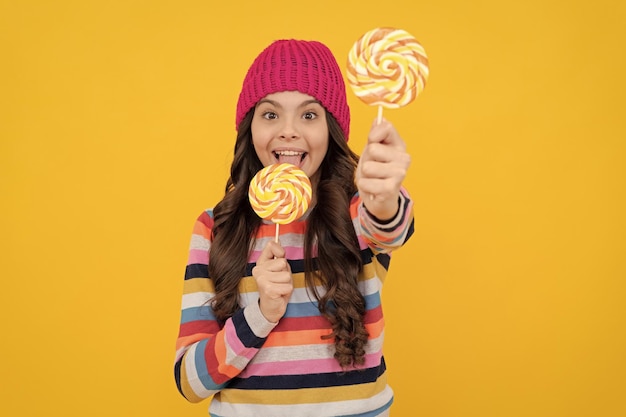 Yummy selective focus happy teen girl licking lollipop lollipop lady kid with colorful lollypop