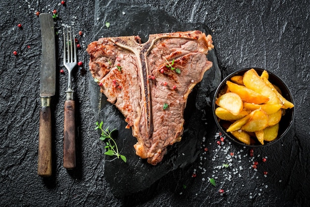 Yummy tbone steak and chips with salt and pepper