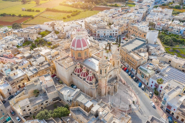 Zabbar Parish Church on the island of Malta, aerial view above, around typical houses buildings.