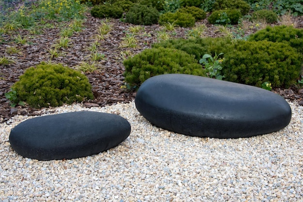 Zen garden dry landscape or karesansui japanese rock garden with black stones on white gravel for re...