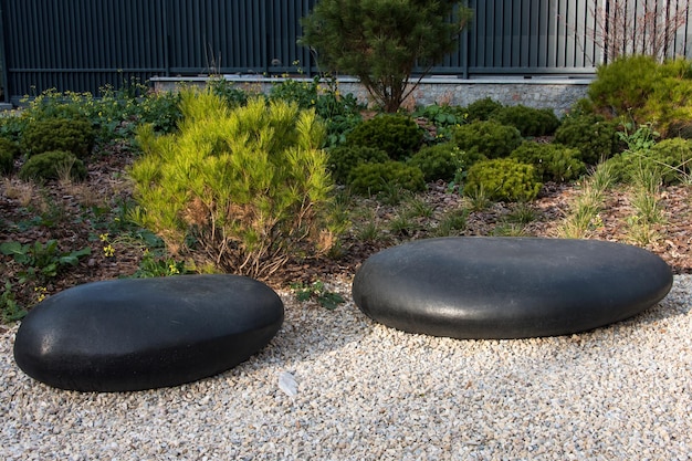 Zen garden dry landscape or karesansui japanese rock garden with black stones on white gravel for re...