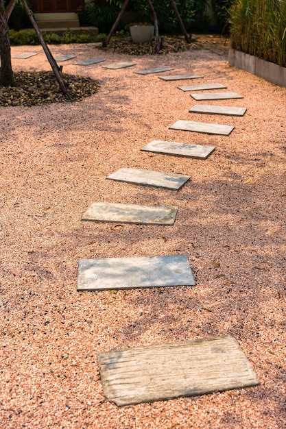 Zen stone path on gravel floor in the garden