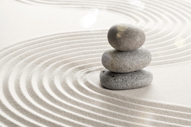 Zen stones in the sand. Beige background