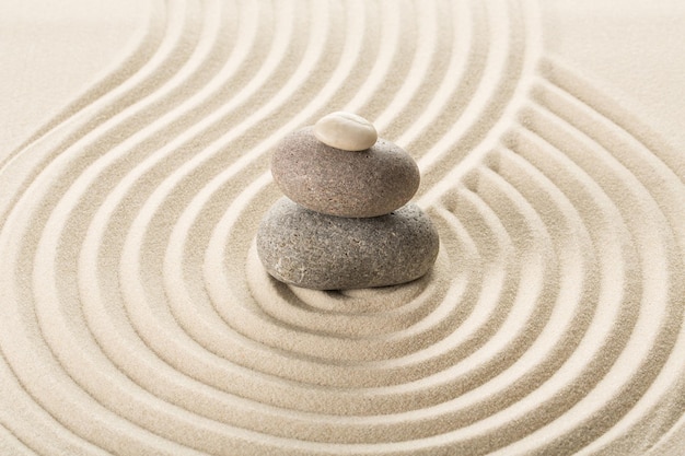 Zen stones in the sand. Grey background