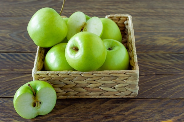 Zero waste concept. No plastic concept. water hyacinth box with ripe green apples on wooden background.