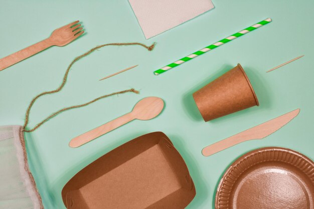 Zero waste environmentally friendly disposable cardboard paper utensils on a blue background