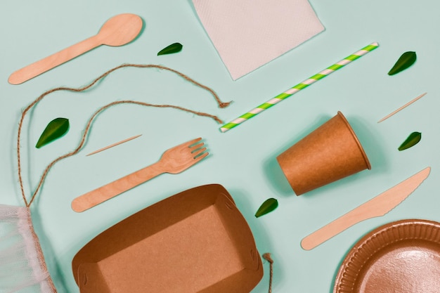 Zero waste environmentally friendly disposable cardboard paper utensils on a blue background