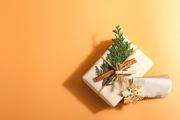 Zero waste gift concept. Christmas or New Year eco-friendly packaging. Festive boxes in craft paper with different organic decorations. Trendy hard light, dark shadow, top view, flat lay