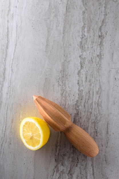 Zesty Citrus Delight CloseUp of Lemon and Lime Fruit with a Wooden Hand Tool Squeezer in 4k