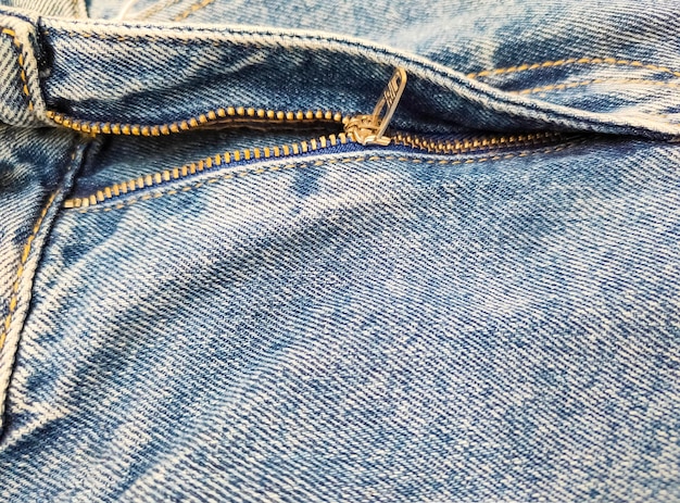 Zipper on jeans Jeans texture Closeup denim background Unzipped jeans