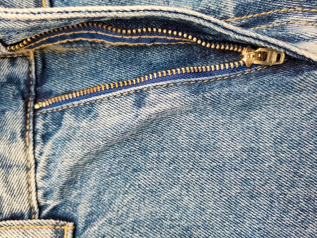 Zipper on jeans Jeans texture Closeup denim background Unzipped jeans