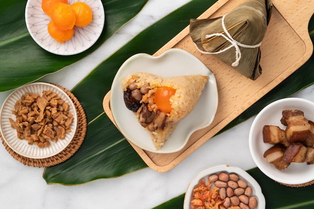 Zongzi Rice dumpling for Dragon Boat Festival on bright marble table background with ingredient