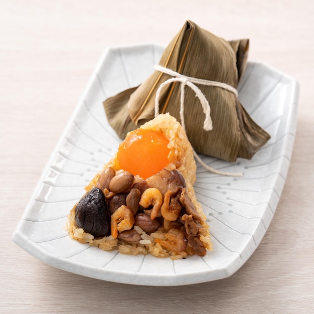 Zongzi rice dumpling for Dragon Boat Festival on wooden table background with ingredient