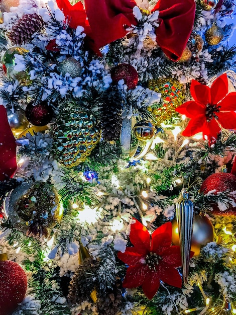 Zoomed View of Fully Decorated and Lit Christmas Tree. Christmas greeting picture. Noel. Background of lights garland. Happy New Year. Front view. High quality photo.