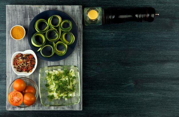 Zucchini in the background. Fried young sliced courgettes in a pan on a dark background. The view from the top. Copy space