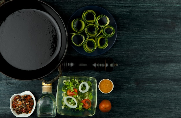 Zucchini in the background. Fried young sliced courgettes in a pan on a dark background. The view from the top. Copy space