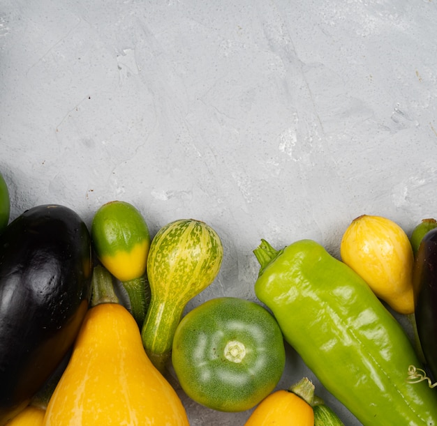 Zucchini, eggplant lie on a light gray background, harvest