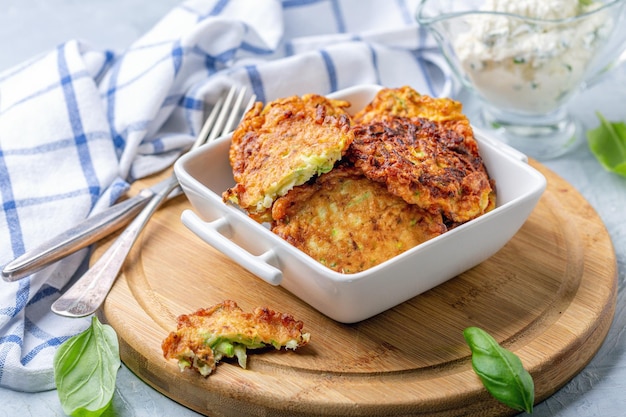 Zucchini pancakes with sour cream sauce