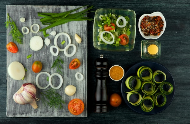 Zucchini in the table. Fried young sliced courgettes in a pan on a dark table. The view from the top. Copy space