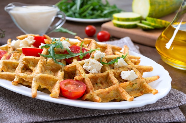 Zucchini waffles with goat cheese, tomatoes, arugula