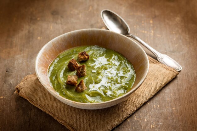 Zucchinis soup with crusty bread and cream sauce