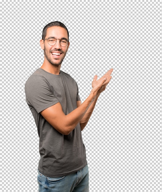 Amazed young man making a gesture of welcome