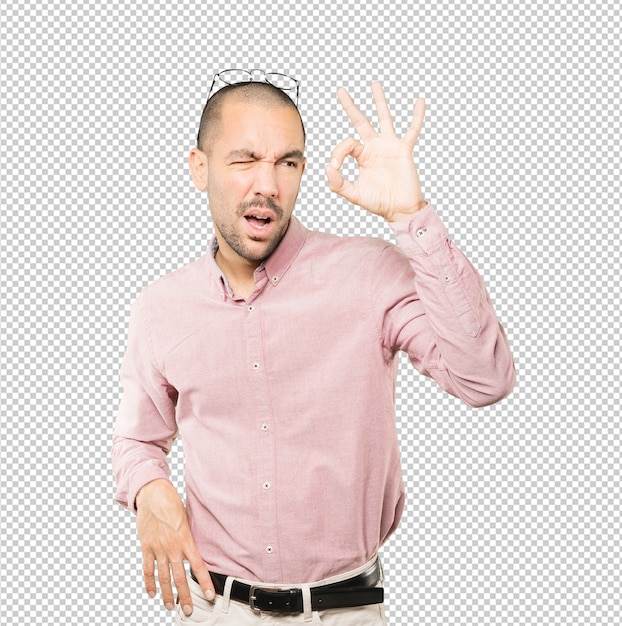 Amazed young man using his hands like a binoculars