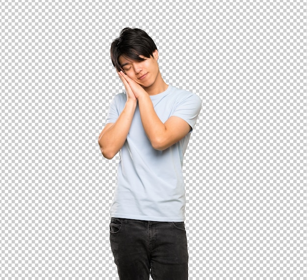 Asian man with blue shirt making sleep gesture in dorable expression