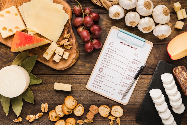 Assortment of delicious types of food with clipboard mock-up