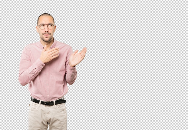 Astonished young man with a gesture of shock