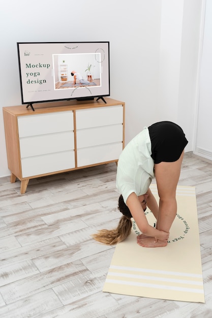 Athletic woman doing yoga at home