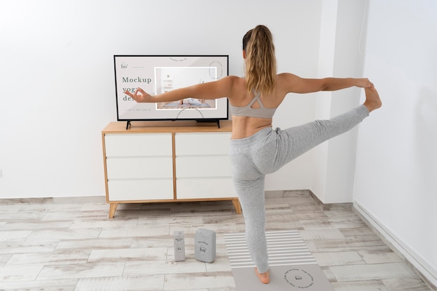 PSD athletic woman doing yoga at home